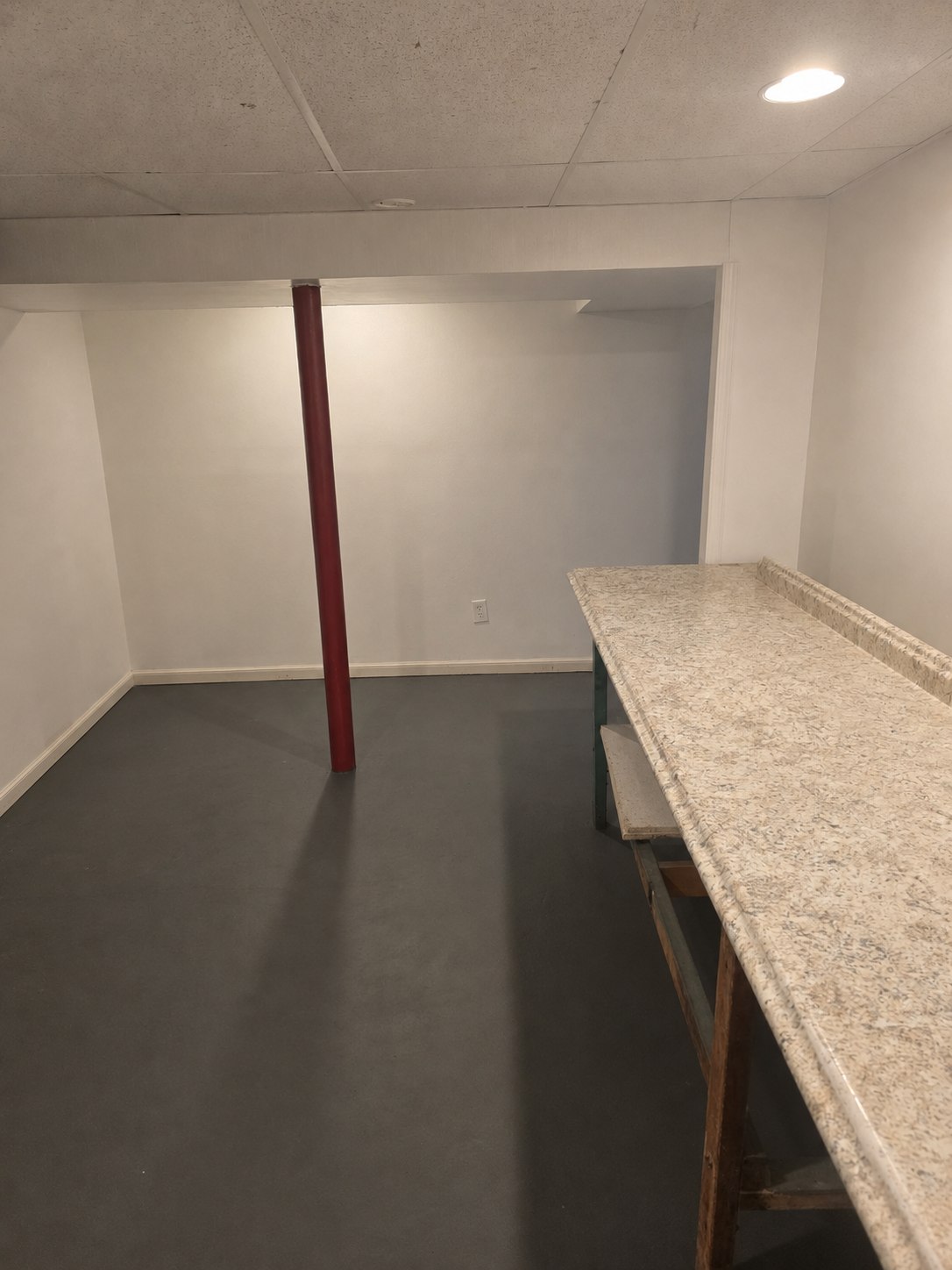 Lower-level workroom with long counter and open floor area