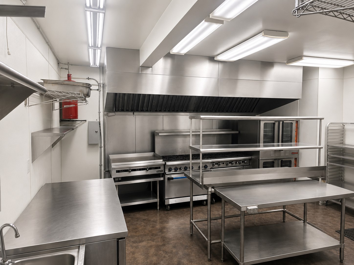 Wide view of the commercial production kitchen and stainless prep area
