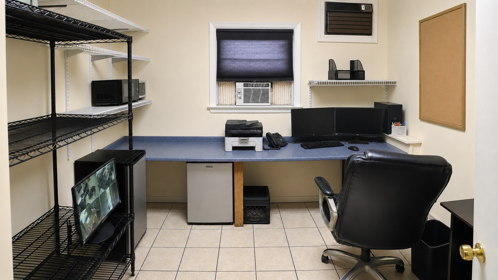 Main-level office with built-in work surface, shelving, desk chair, and window